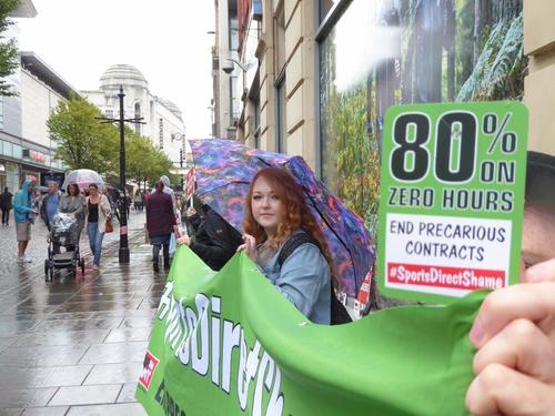 Protestors gather in Manchester outside a Sports Direct shop Credit: Christy Kidd